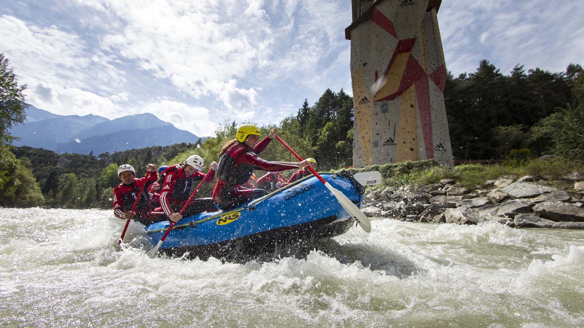 Sölden: offers with so many advantages Group white-water rafting on river near climbing wall in background